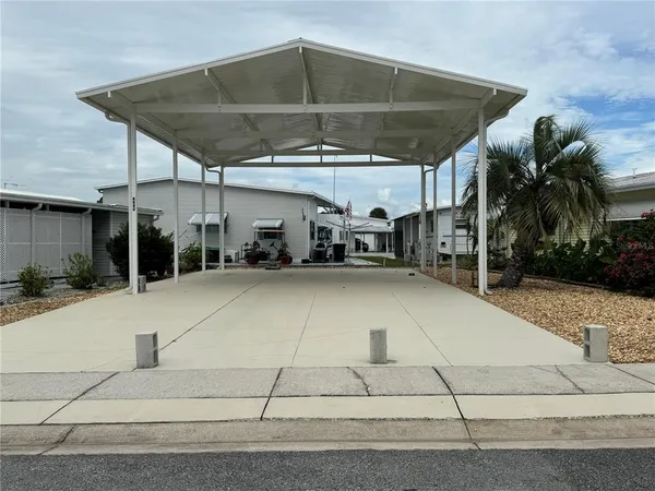 a view of a patio with table and chairs under an umbrella