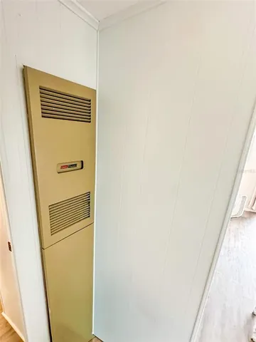 a backyard of a house with table and chairs and wooden fence