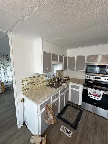 a kitchen with a stove and a microwave