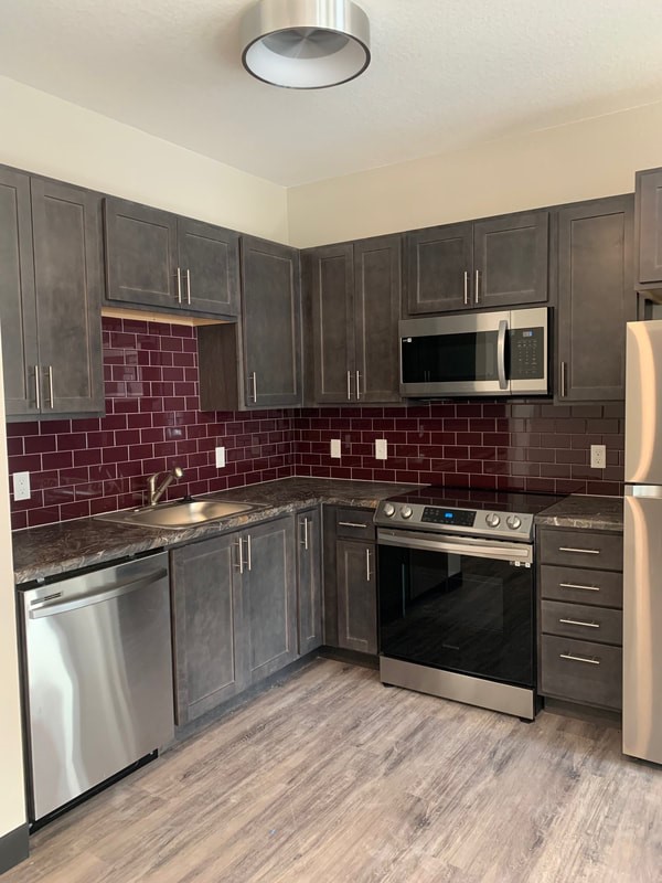 5352 Allison Street Arvada, CO 80002 - Photo 7 of 10 a kitchen with granite countertop a stove sink and cabinets