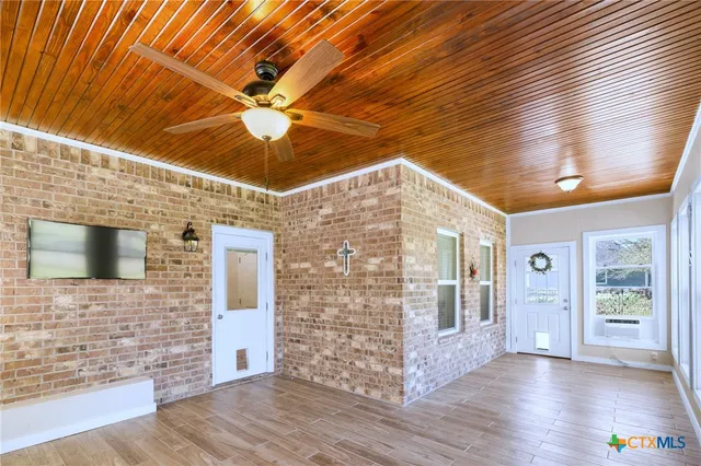 a bedroom with a bed a dresser and a window