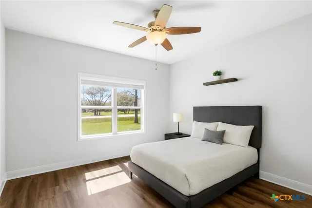 a bedroom with a bed lamp and window