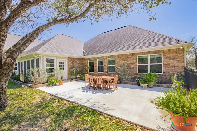 a view of a house with a yard patio and a fire pit