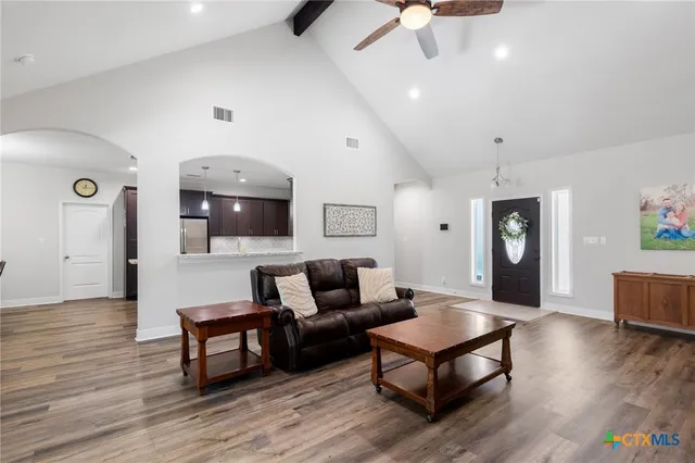 a living room with furniture and wooden floor
