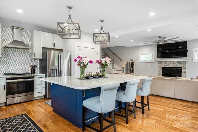 a view of a dining room with furniture wooden floor and a kitchen
