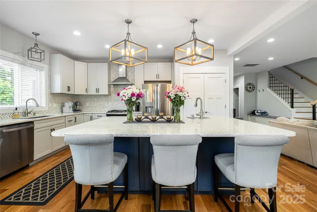 a kitchen with a dining table chairs sink and microwave
