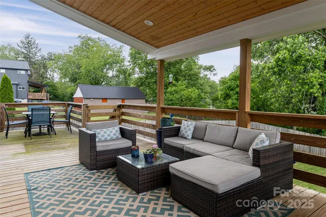 a living room with patio furniture and a potted plant