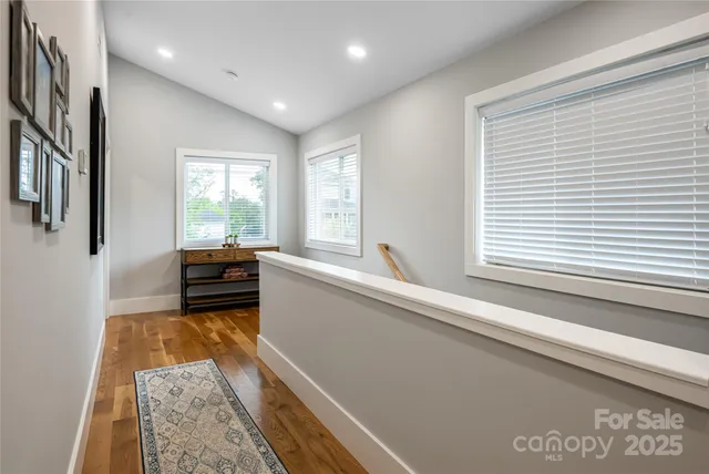 a view of a kitchen with kitchen island a large window a sink and a counter top space