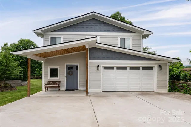 a view of a house with a yard and garage