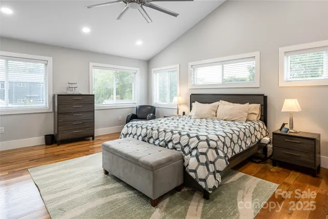 a bedroom with a bed and wooden floor