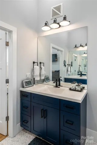 a bathroom with a sink double vanity and a mirror