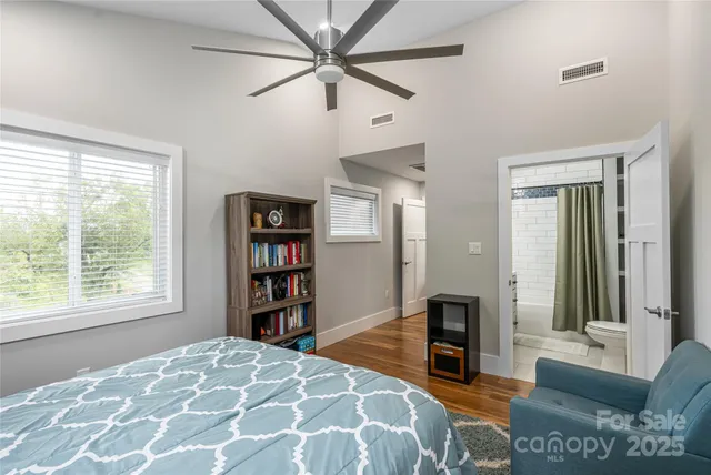 a bedroom with a large bed and a bookshelf