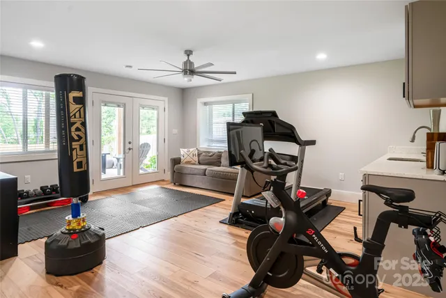 a view of a livingroom with furniture and gym equipment