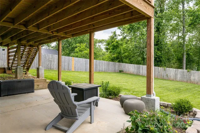 a view of a patio with chairs and a backyard