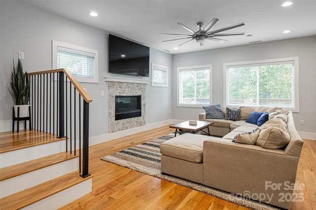 a living room with furniture a fireplace and a flat screen tv