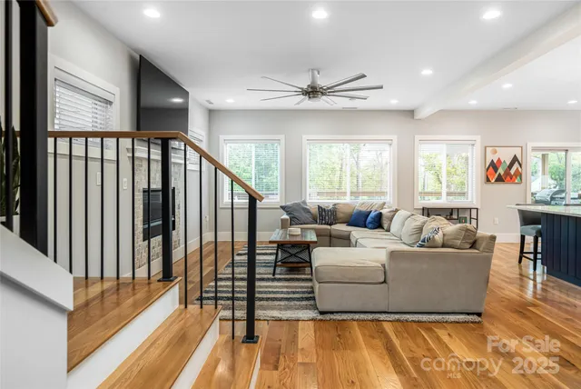 a living room with furniture and a chandelier