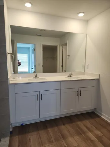 a kitchen with a refrigerator and white cabinets