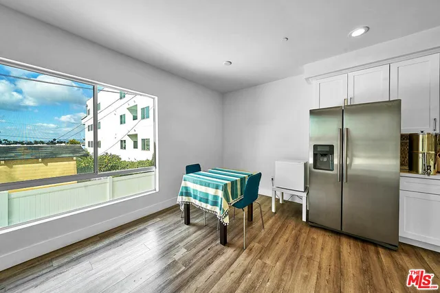 a kitchen with sink and refrigerator