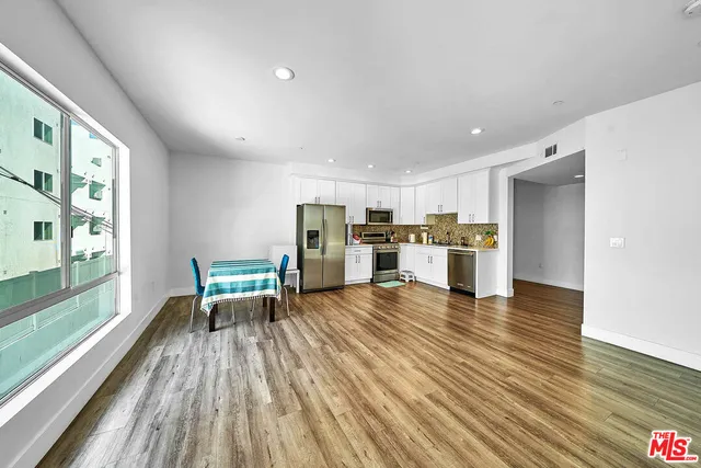 a view of kitchen with furniture and wooden floor