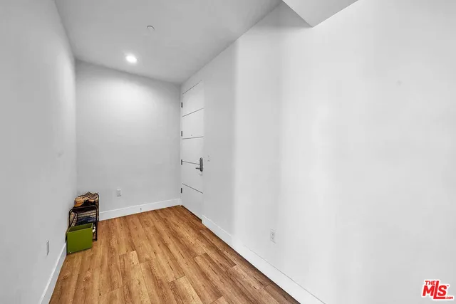 a view of a room with wooden floor and a sink