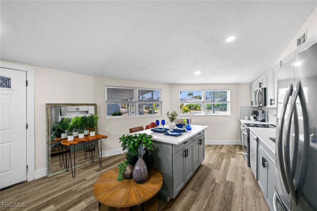 190 Tarpon Road Fort Myers Beach, FL 33931 - Photo 12 of 47 a living room with furniture potted plant and kitchen view