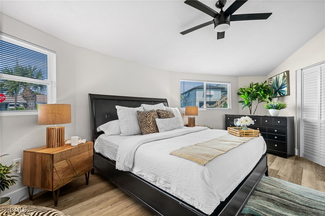 190 Tarpon Road Fort Myers Beach, FL 33931 - Photo 15 of 47 a bedroom with bed and a lamp on dresser