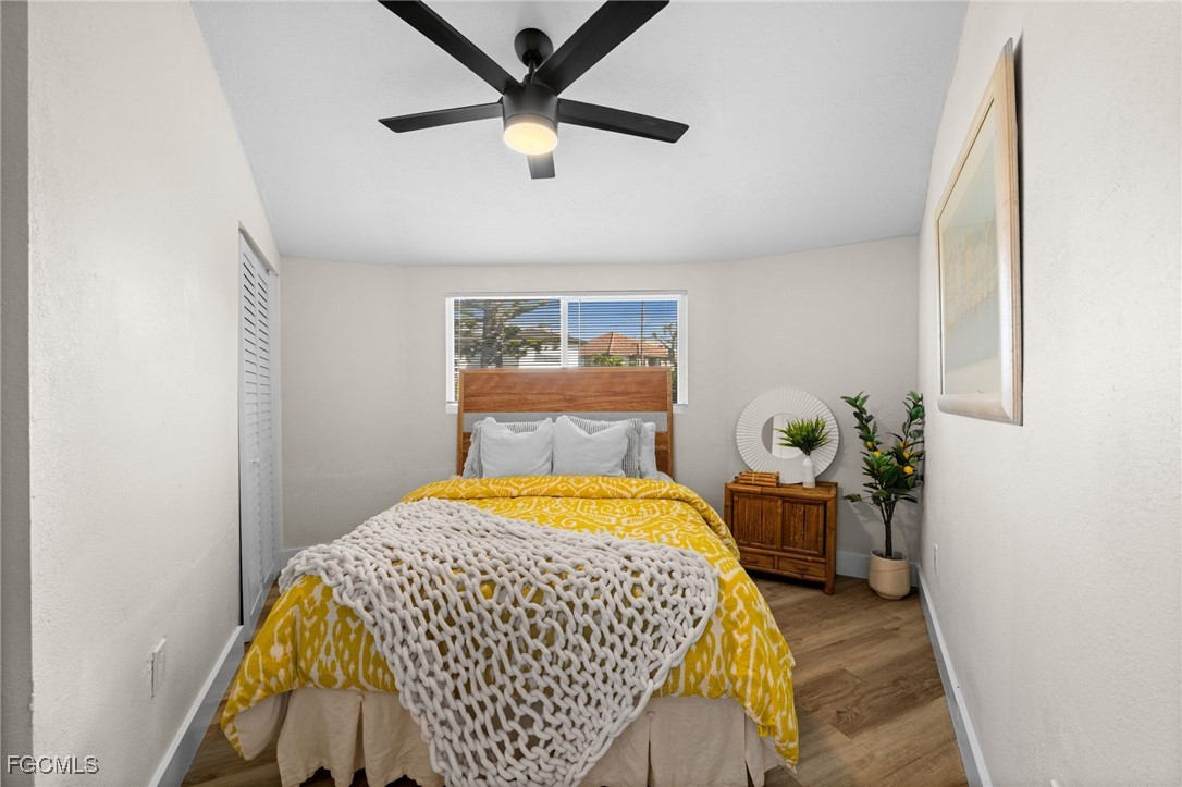 190 Tarpon Road Fort Myers Beach, FL 33931 - Photo 22 of 47 a bedroom with a bed and wooden floor