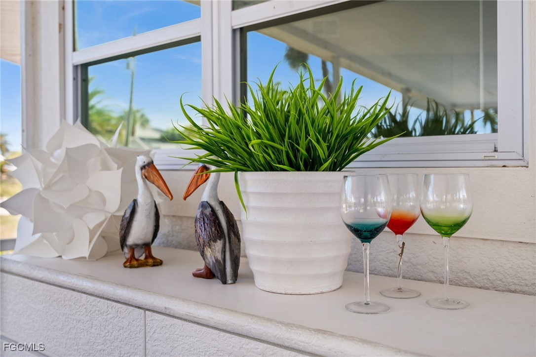 190 Tarpon Road Fort Myers Beach, FL 33931 - Photo 34 of 47 a vase of flowers sitting on a table with kitchen chandelier