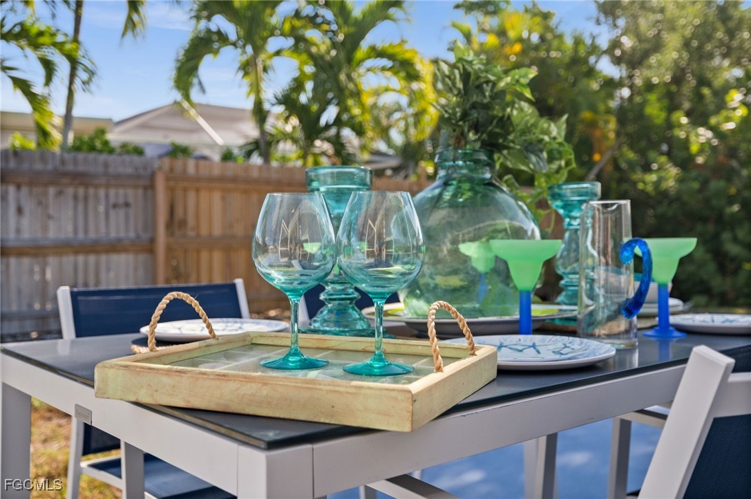 190 Tarpon Road Fort Myers Beach, FL 33931 - Photo 40 of 47 a table with chairs and a vase of flowers