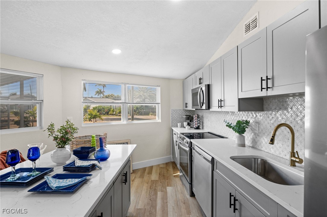 190 Tarpon Road Fort Myers Beach, FL 33931 - Photo 5 of 47 a kitchen that has a sink and cabinets