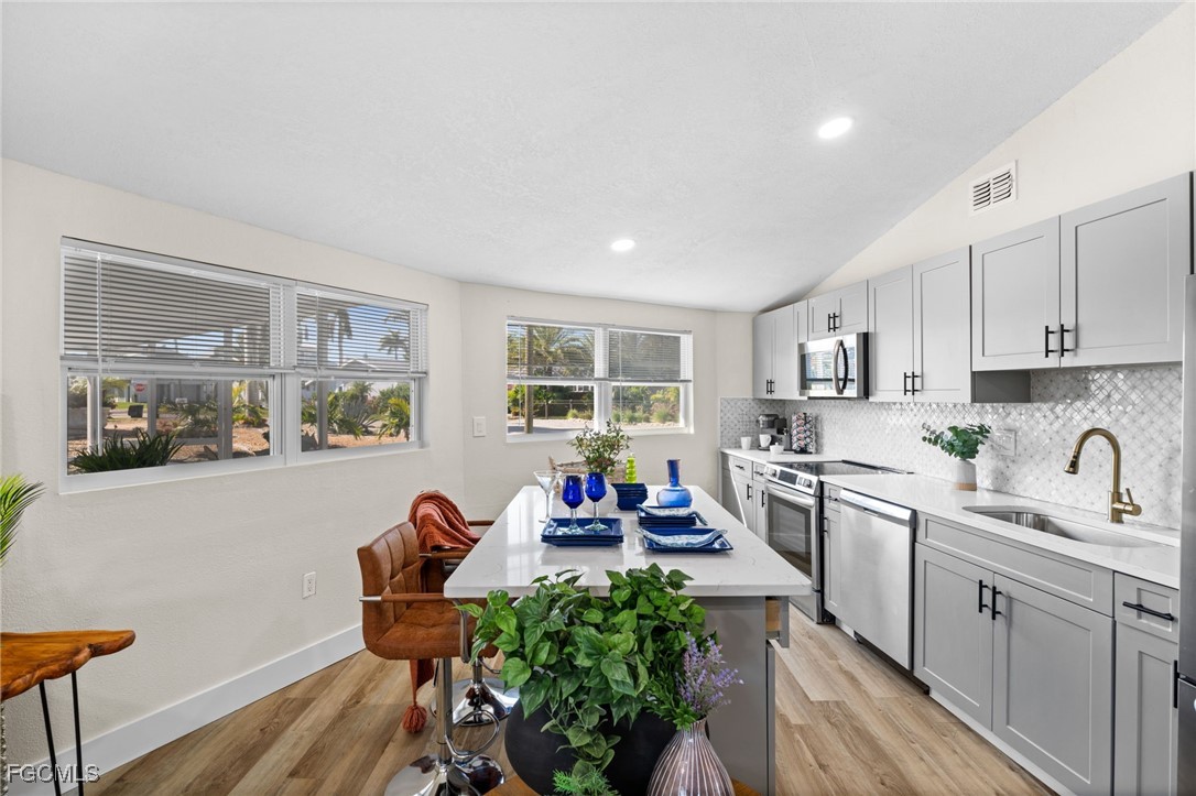 190 Tarpon Road Fort Myers Beach, FL 33931 - Photo 10 of 47 a kitchen with a table chairs stove and cabinets
