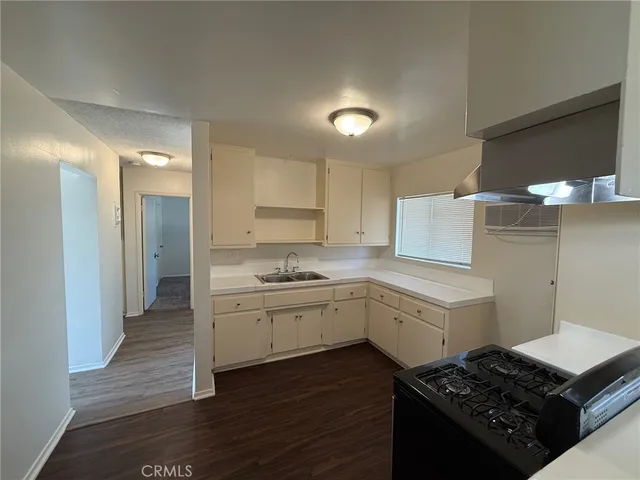 a kitchen with a sink stove and cabinets