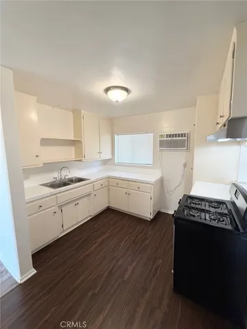 a kitchen with a cabinets and white appliances