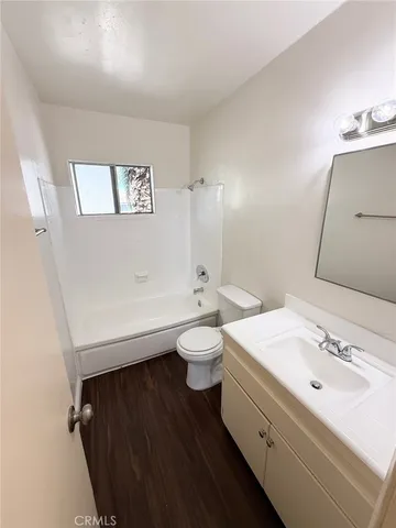 a bathroom with a double vanity sink toilet and a mirror