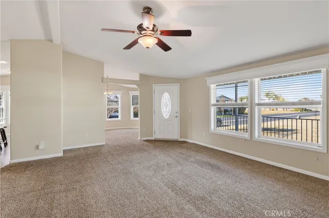 a kitchen with stainless steel appliances kitchen island granite countertop a sink a stove a refrigerator cabinets and a dining table