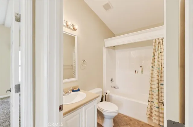 a view of a house with a yard and potted plants
