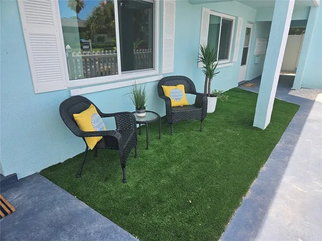 a view of a house with backyard porch and sitting area