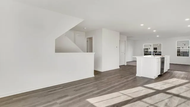 a view of a kitchen with wooden floor and electronic appliances