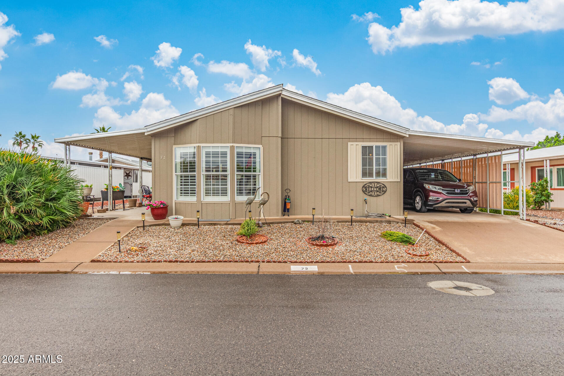 a view of a house with a patio and a yard