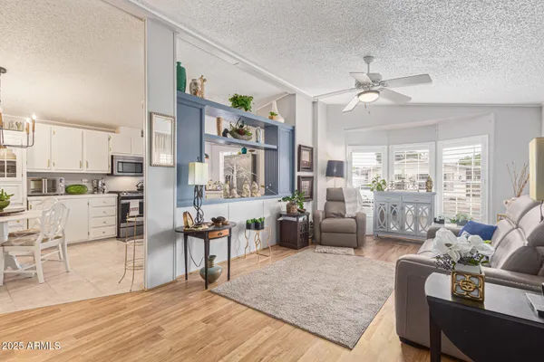 a living room with furniture kitchen view and a dining table