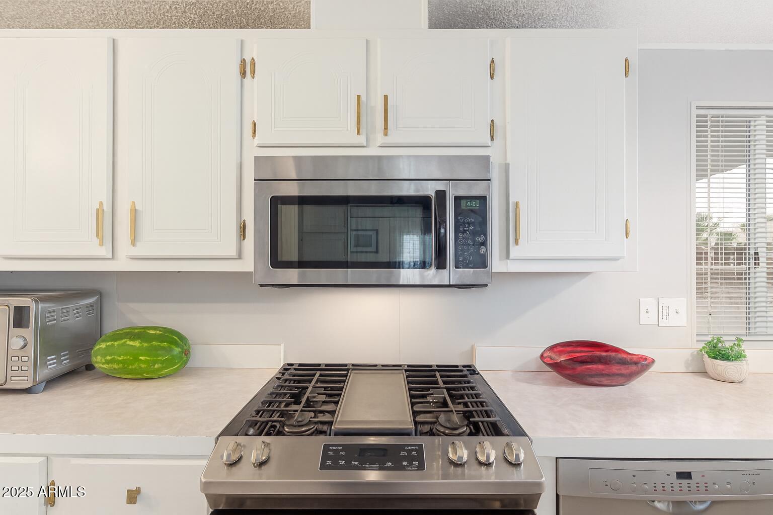 1102 South 114th Street, Unit 72 Mesa, AZ 85208 - Photo 15 of 20 a kitchen with a stove and cabinets
