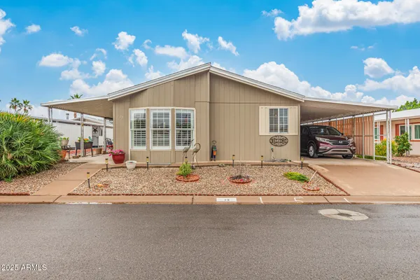 a view of a house with a patio and a yard