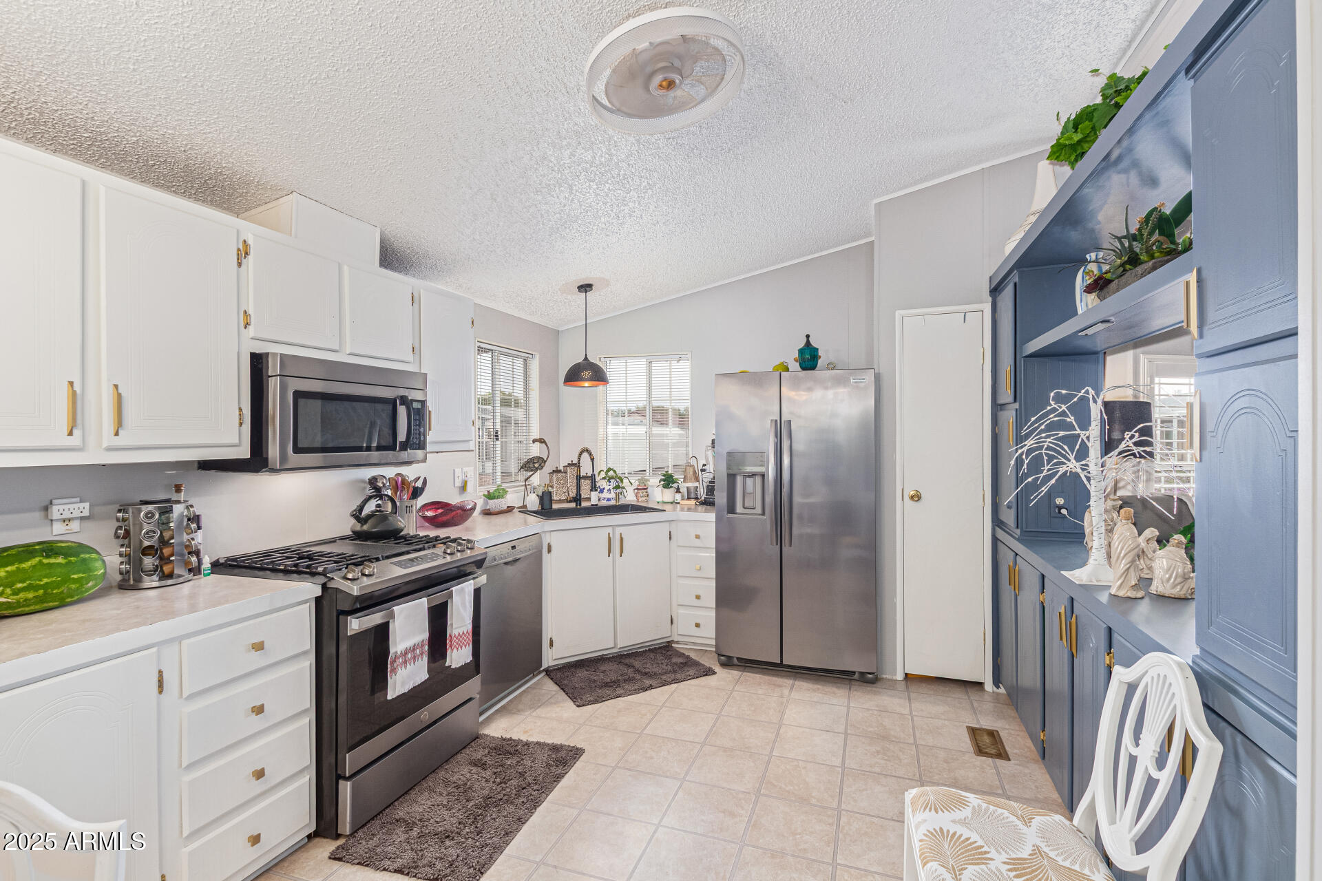 1102 South 114th Street, Unit 72 Mesa, AZ 85208 - Photo 2 of 20 a kitchen with stainless steel appliances granite countertop a refrigerator sink and cabinets
