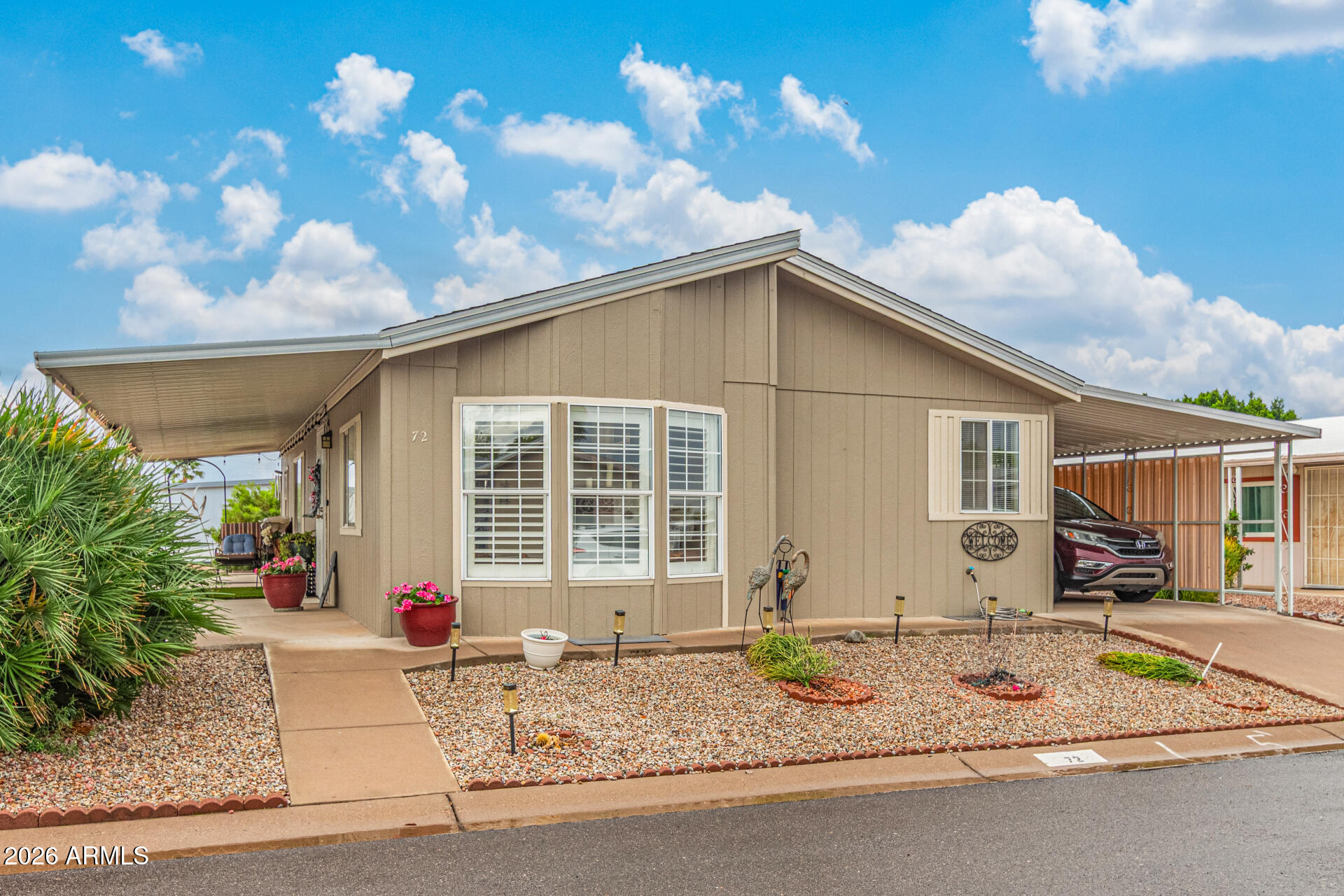 1102 South 114th Street, Unit 72 Mesa, AZ 85208 - Photo 3 of 20 a front view of a house with garden