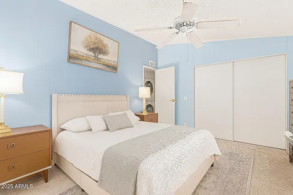a bedroom with a bed and a chandelier