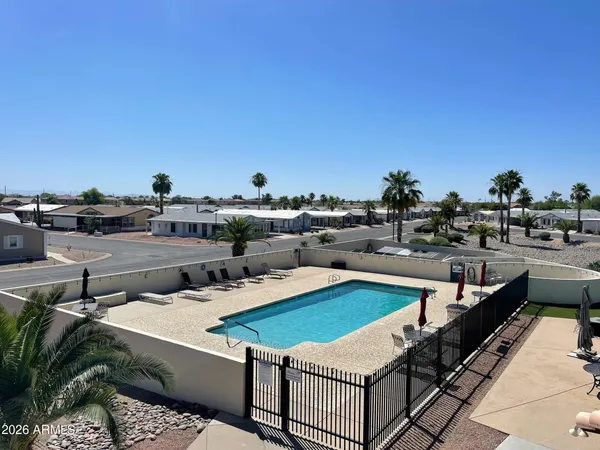 a view of a swimming pool with outdoor seating
