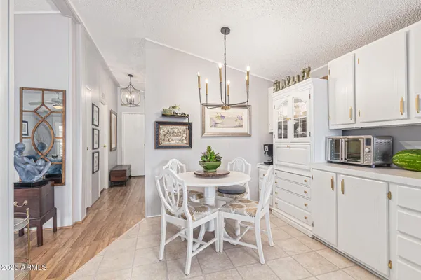 a kitchen with stainless steel appliances kitchen island granite countertop furniture and a refrigerator