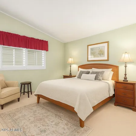 a bedroom with a bed and a couch