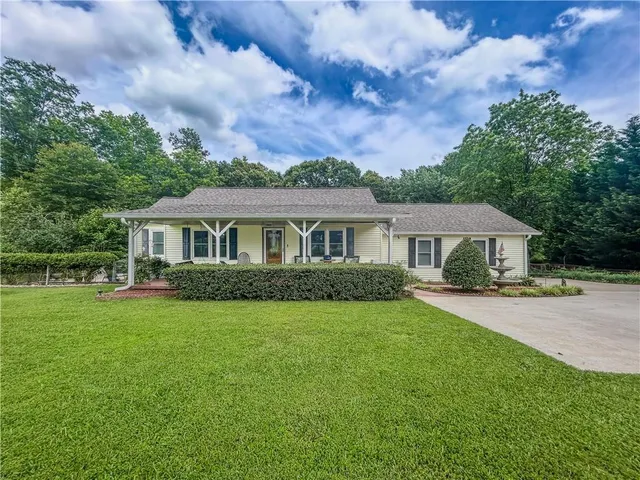 a front view of a house with a garden