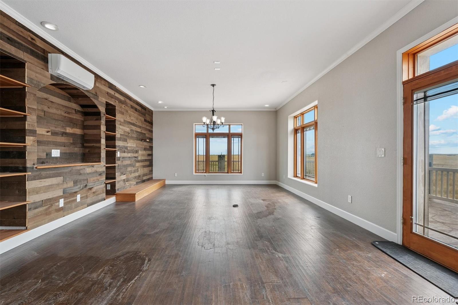 2105 Timberlake Road Byers, CO 80103 - Photo 11 of 48 a view of an empty room with wooden floor and a window